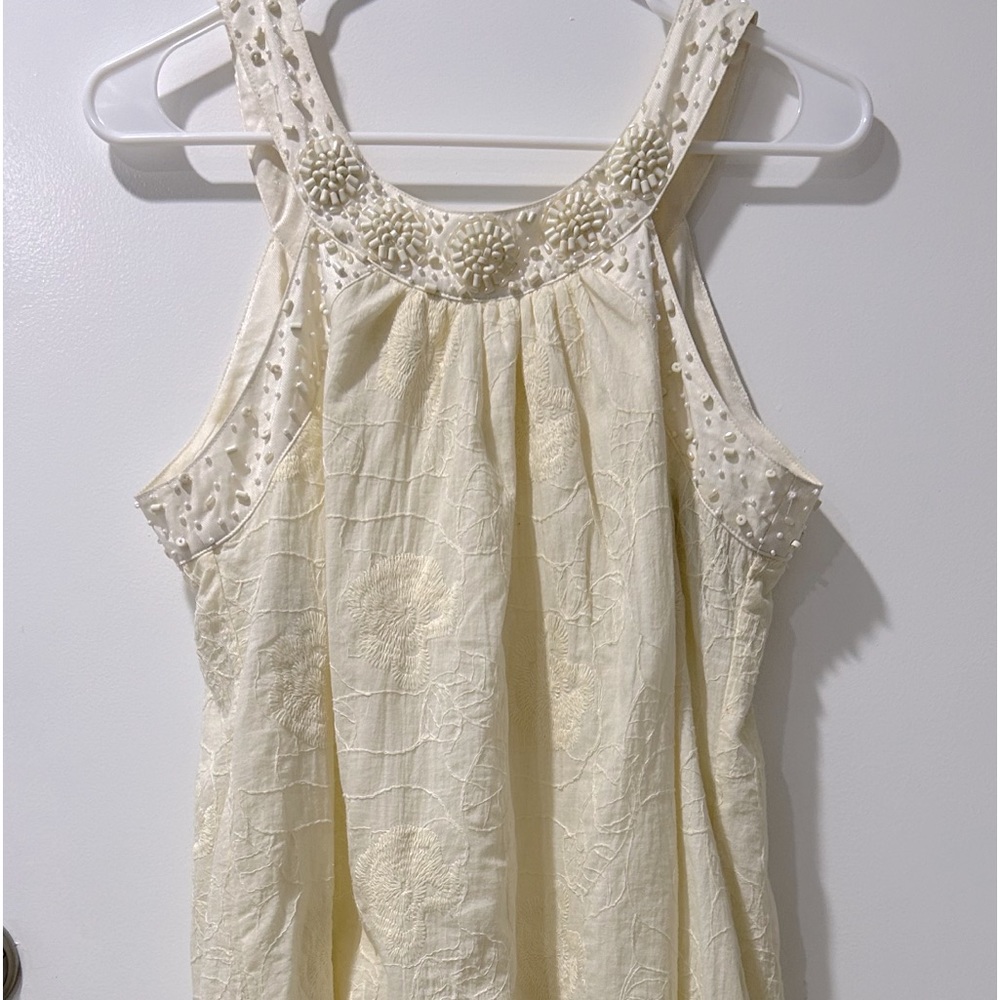 Never worn Theme mini dress! With hand woven beads around shoulder and neck area